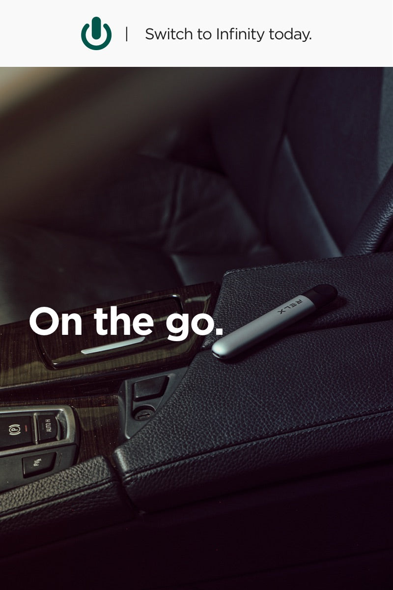 RELX Infinity Device lying in car interior - RELX on the Go
